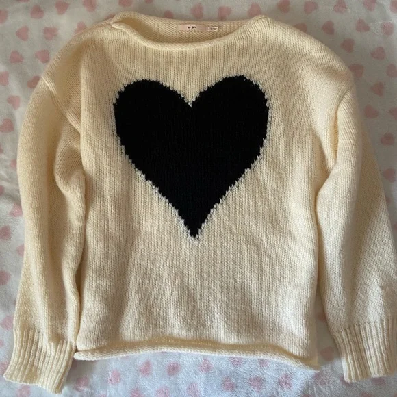 cream colored sweater with black heart